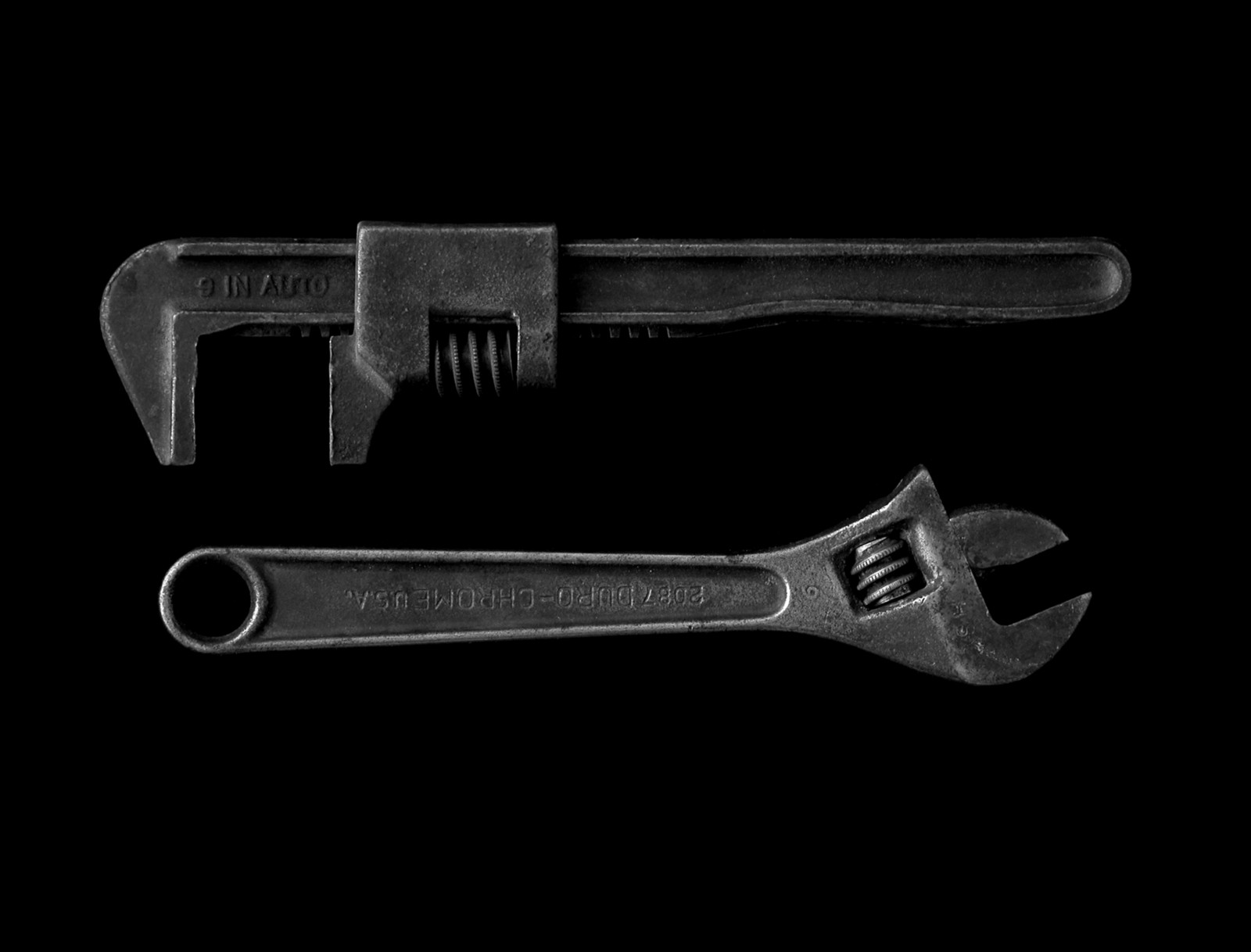 two wrenches on a black background